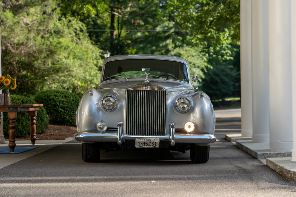 rolls royce parked under a portico