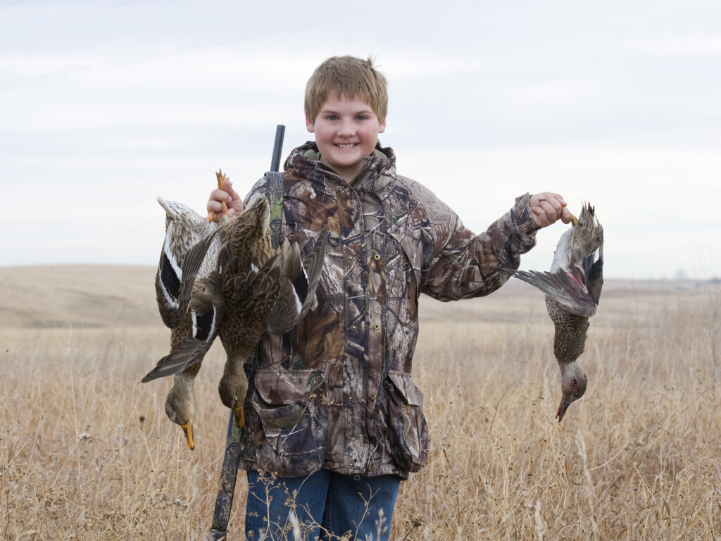 Boy with several Ducks from a duck hunt
