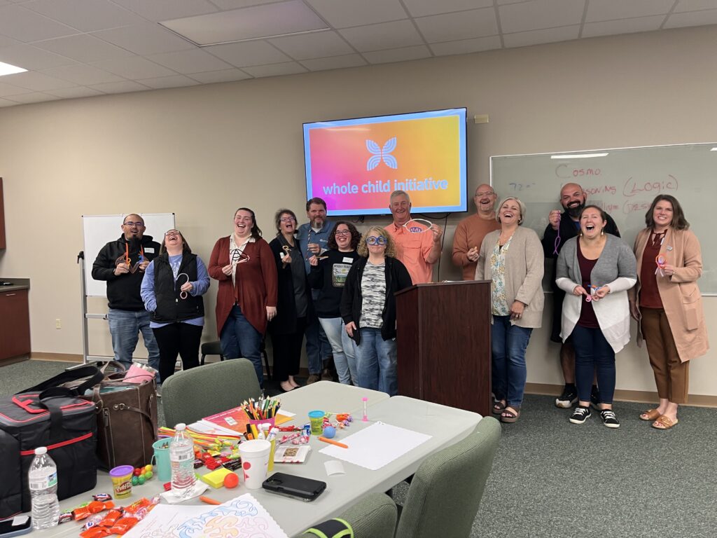 group of people gather for a photo at a trauma-informed foster care training session hosted by palmer home for children's whole child initiative