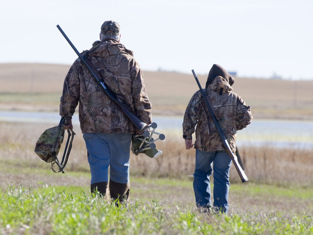 man and young boy duck hunting