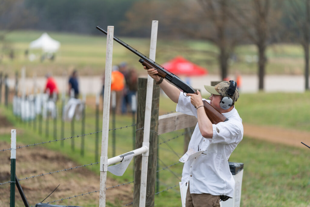 man holding gun at a clay shoot